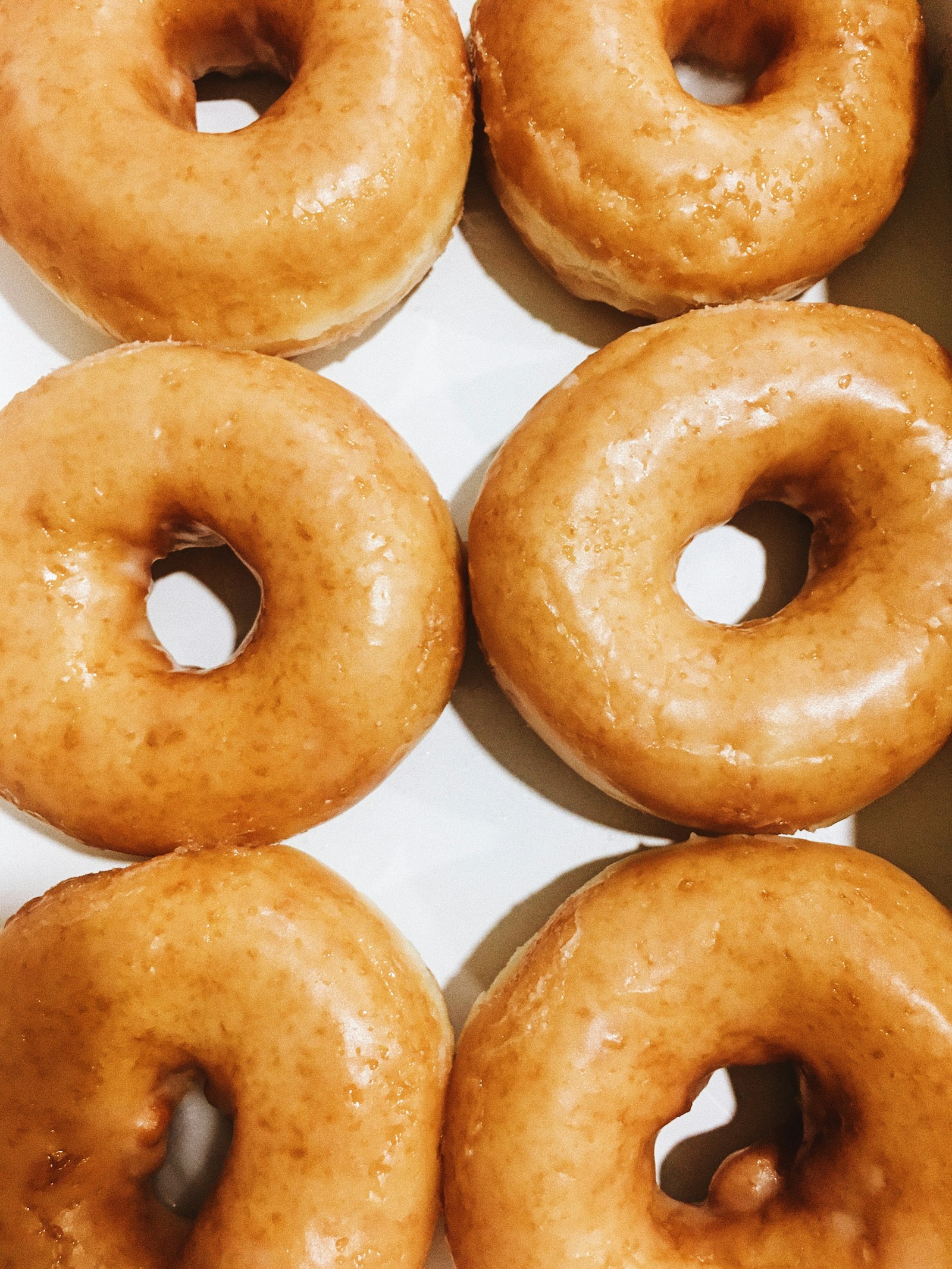 Rows of classic glazed donuts